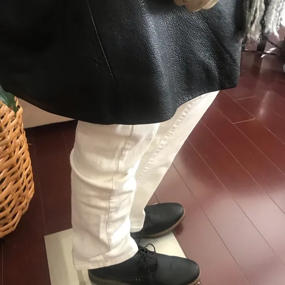 Black leather jacket by a USA designer, and with black sheepskin insulation .