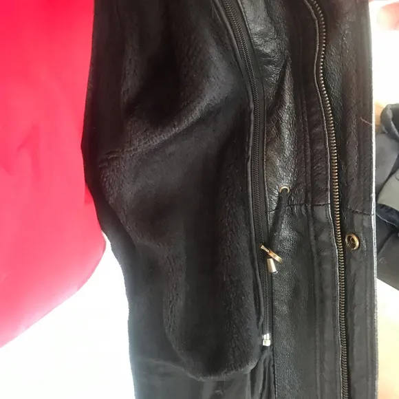 Black leather jacket by a USA designer, and with black sheepskin insulation .