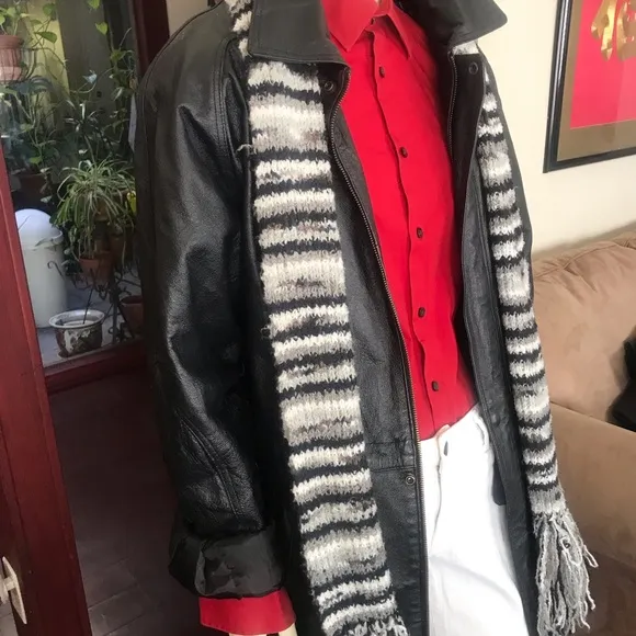 Black leather jacket by a USA designer, and with black sheepskin insulation .