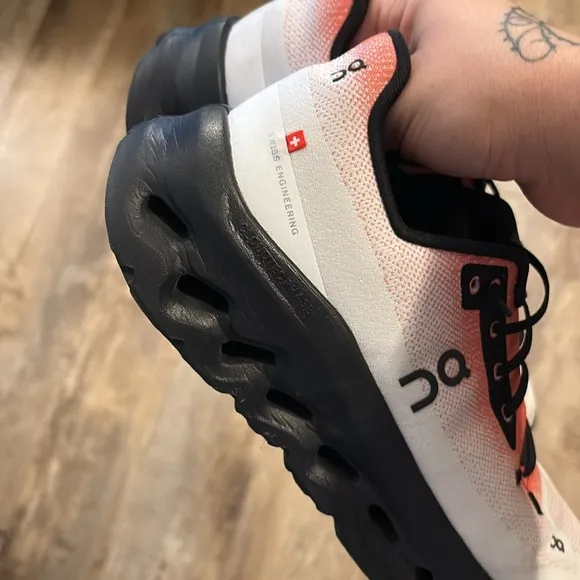 On Running Black and Orange Sneakers with CloudTec Cushioning