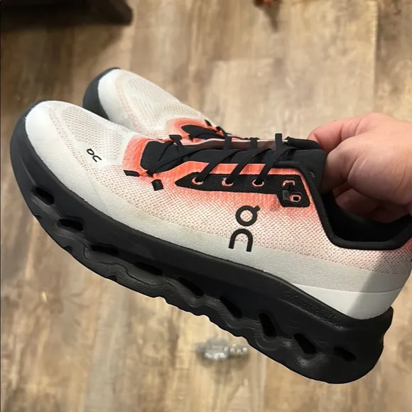 On Running Black and Orange Sneakers with CloudTec Cushioning